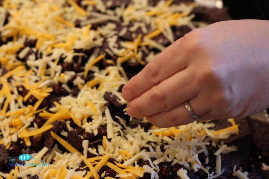 Adding the cheese | Black Bean and Cheese Nachos | The Mama Maven Blog