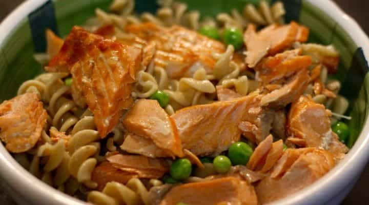 Lemon Garlic Salmon over Whole Wheat Pasta Ingredients: Tessamae Lemon Garlic Dressing and Marinade Frozen (or fresh) wild salmon - 2 pieces Whole wheat rotini Frozen (or fresh) peas Instructions: Defrost Salmon in hot water. Line a baking sheet or pan with parchment paper or foil, add Tessamae's Lemon Garlic Dressing and Marinade on top. Note: If I had more time, I would have marinated it for a while. Broil on high for 9 minutes or so. Make whole wheat rotini pasta. Before you drain pasta, put frozen peas at the bottom of the colander so the hot water will warm them. Flake salmon. Add pasta and peas to bowl. Add more Tessamae's Lemon Garlic Dressing. Add flaked salmon on top and serve!