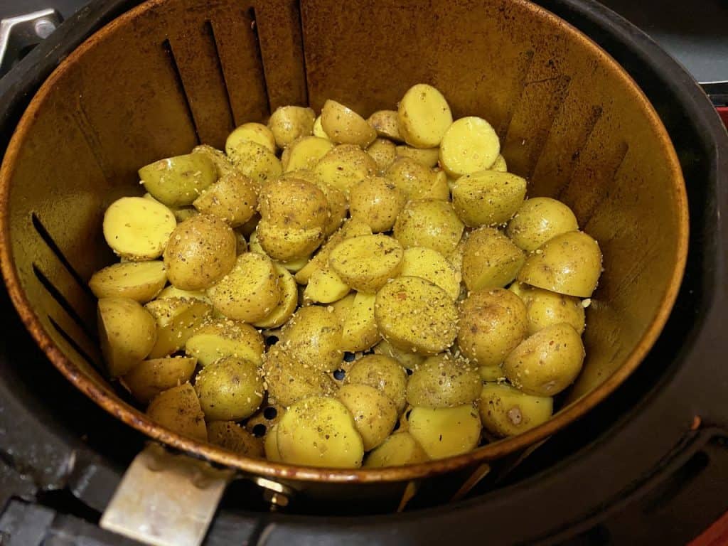 Putting potatoes in air fryer