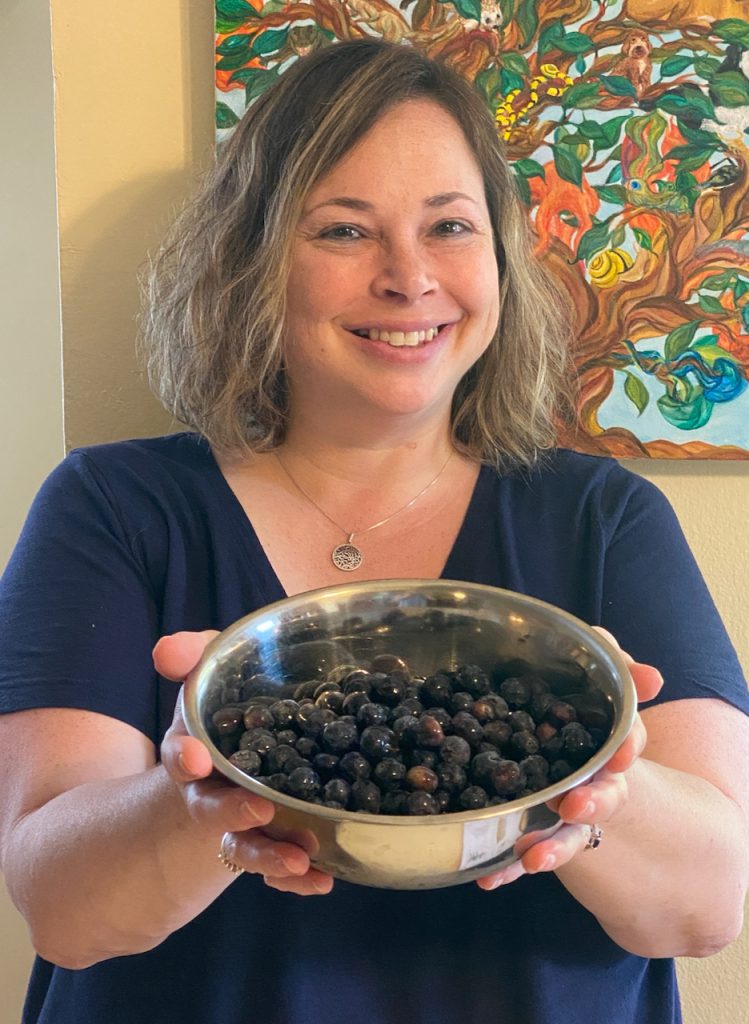 Woman holding a bowl of blueberries