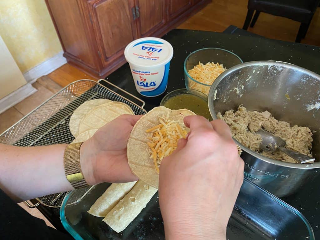 Assembling Gluten Free Chicken Enchiladas Suizas