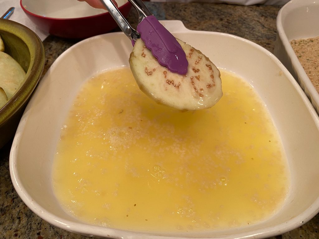 Eggplant being dipped in Eggland's Best Egg Whites