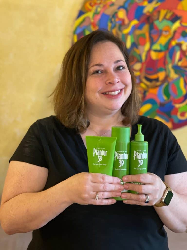 Woman holding shampoo