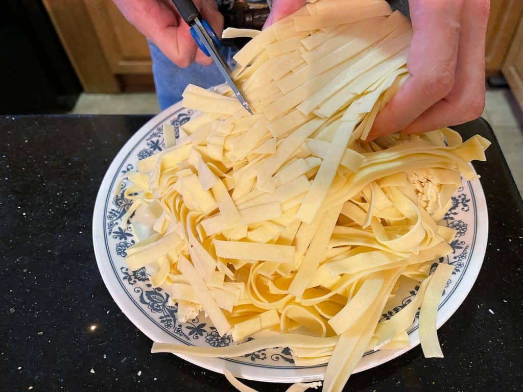 Cutting up egg fettuccine