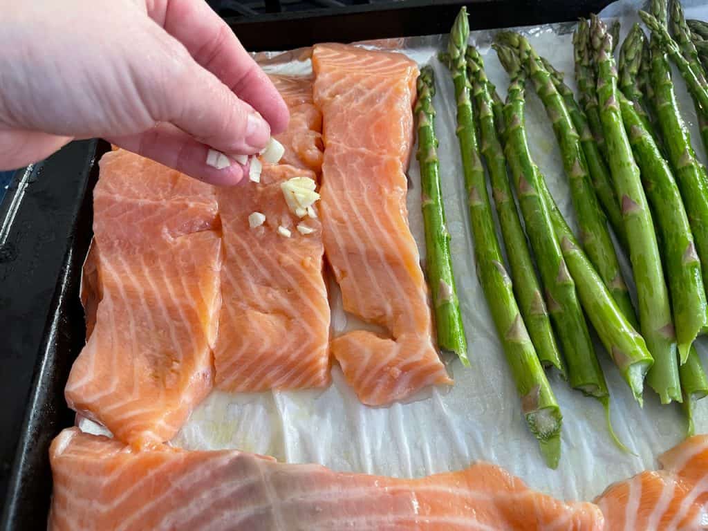 Adding garlic to salmon