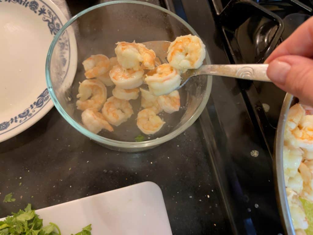 Taking shrimp out of the pan