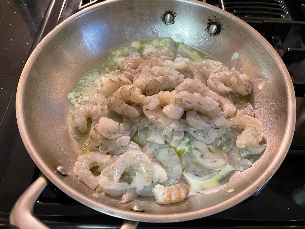 Adding shrimp to pan