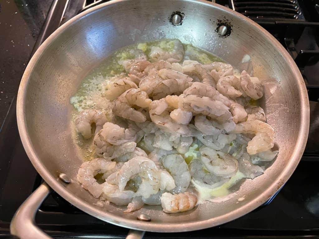 Adding shrimp to pan