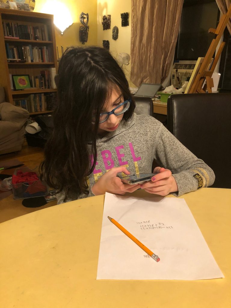 Child using phone to help with Math