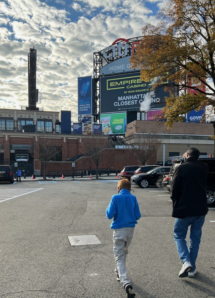 Child and dad walking into CitiField to get Covid-19 Vaccine 2021- The Mama Maven Blog