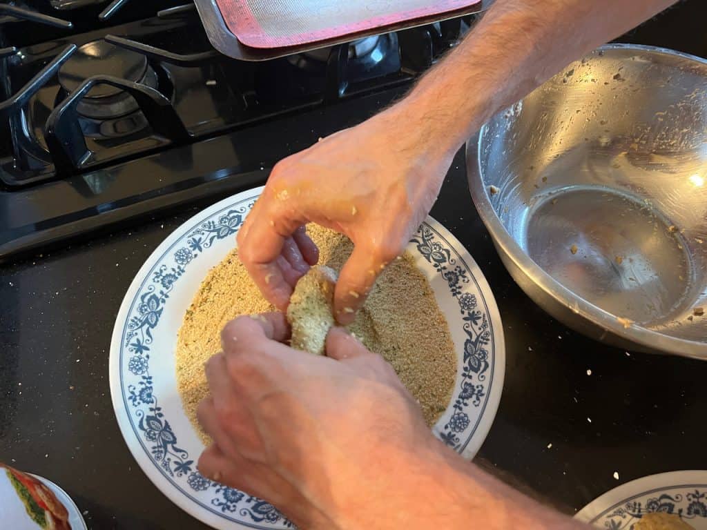 Rolling patties in breadcrumbs