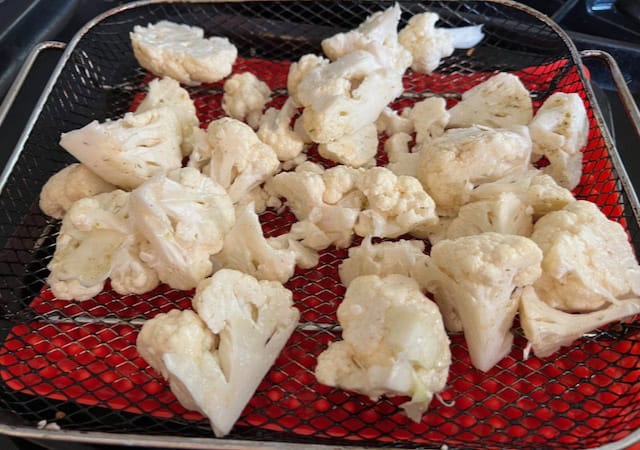 cauliflower on air fryer tray before air frying 