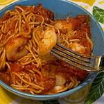 Shrimp Marinara in blue bowl on a lemon tablecloth